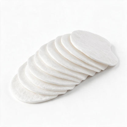 A stack of round white cotton pads arranged in an overlapping fan shape on a clean white background.