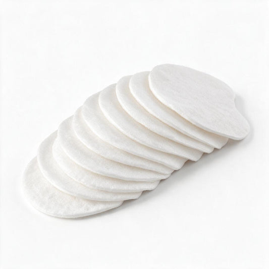 A stack of round white cotton pads arranged in an overlapping fan shape on a clean white background.