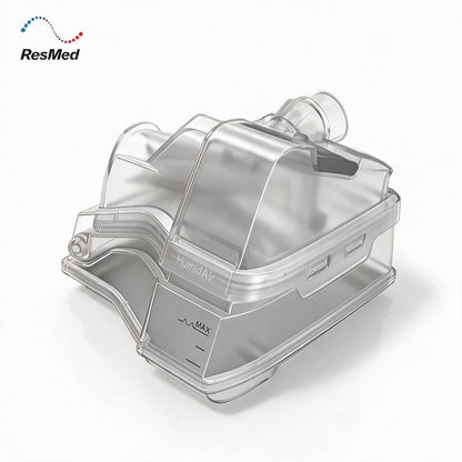 ResMed HumidAir humidifier filter canister, made of transparent clear plastic with a gray base, shown on a white background with the ResMed logo in the top-left corner.