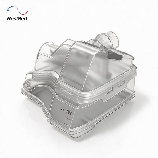 ResMed HumidAir humidifier filter canister, made of transparent clear plastic with a gray base, shown on a white background with the ResMed logo in the top-left corner.